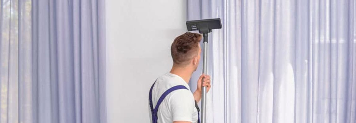 A Professional Cleaner Cleaning Curtains